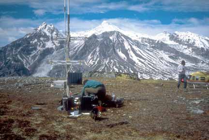 Photograph of two geologists with seismometer and antenna