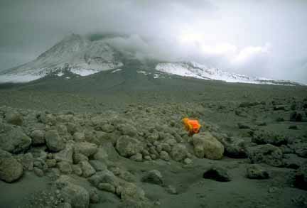 Photograph of geologist among boulders
