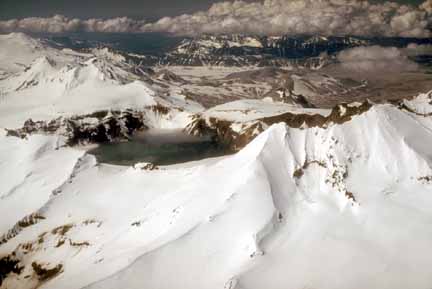 Photograph from air of caldera nearly covered with snow but no ice in lake
