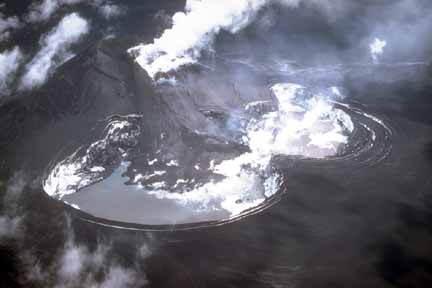 Photograph from air of lava flow from dark cone and steaming lake produced in ice cap filling caldera; all surfaces are dark with ash