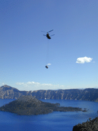 [Photo of helicopter and boat flying towards Wizard Island] 