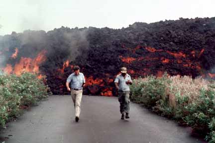 photo 011.  Photo of two men pacing off distance from the lava which is red-hot underneath and gray crusted-over on top.