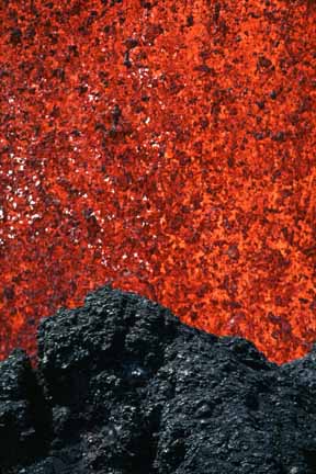 photo 015.  Extreme telephoto shot with top of frame filled with fountaining red-hot lava and foreground showing black crater rim
