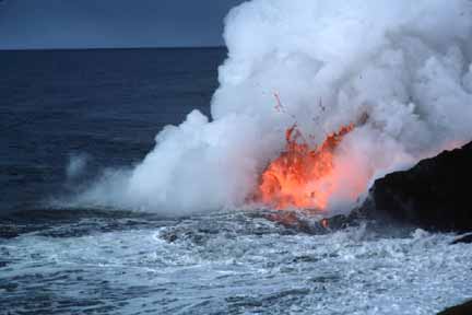 photo 045.  Closer photo of spattering red-hot lava entering sea and billowing steam cloud forming
