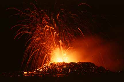 photo 089.  Night photo of lava fountaining from crater.  Slow camera shutter speed caused the trail of hot embers to be shown as thin red arcuate streaks reminiscent of fireworks
