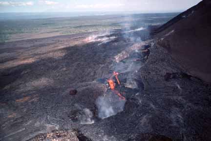 photo 097.  Photo of side of volcano with lava flowing out onto flats