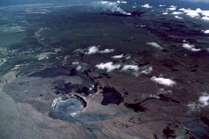 photo 098.  Fairly high-altitude oblique aerial photo of crater with buildings barely visible on the edge